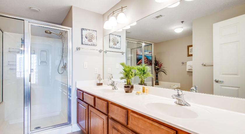 a bathroom with a shower, sink, and mirror, Ariel Dunes I in Destin (FL)