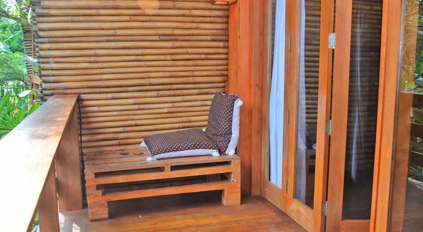 a bed sitting on top of a wooden bench, Lagoona Beach Bungalows - Eco Stay in Pangandaran