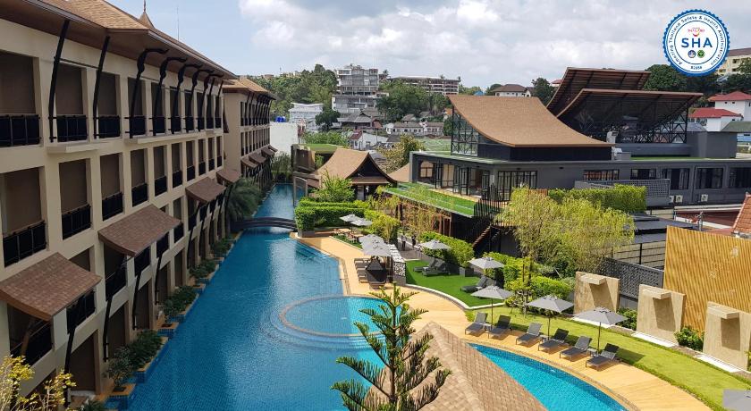 a large building with a pool of water in front of it, Aurico Kata Resort & Spa (SHA Plus+) in Phuket