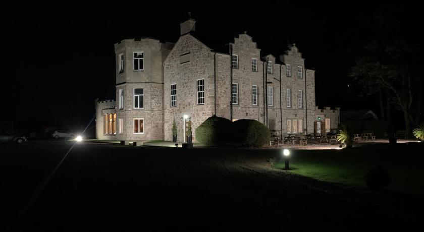 a large building with a clock at the top of it, Shieldhill Castle Hotel in Symington