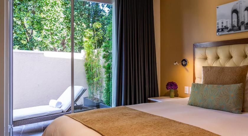a bedroom with a bed and a window, Casa Mali by Dominion Boutique Hotel in Mexico City