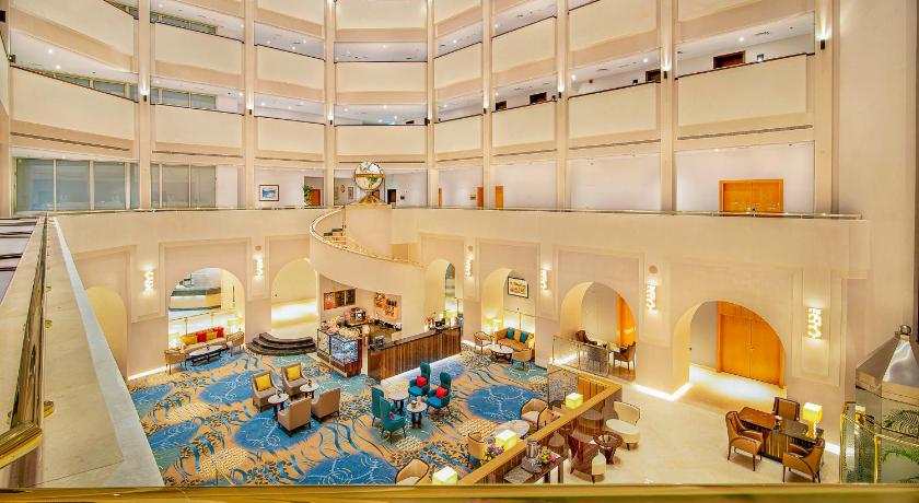 a very large room with a lot of windows, Radisson Blu Hotel and Resort Al Ain in Al Ain