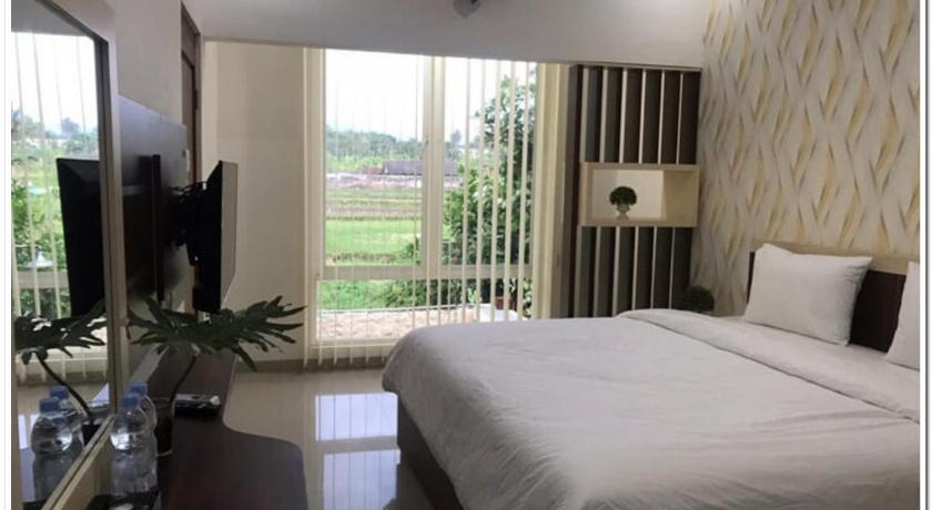a bedroom with a bed and a window, RedDoorz Syariah @ Omah Sawah in Yogyakarta