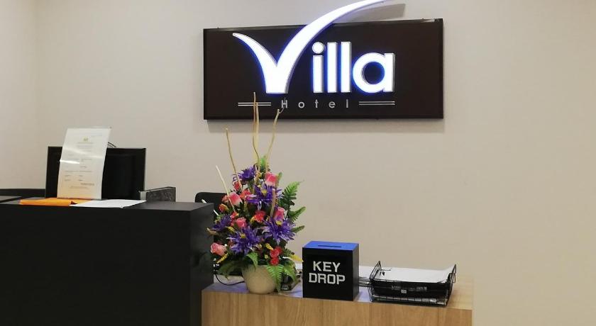 a desk with a clock on top of it, Villa Hotel in Segamat