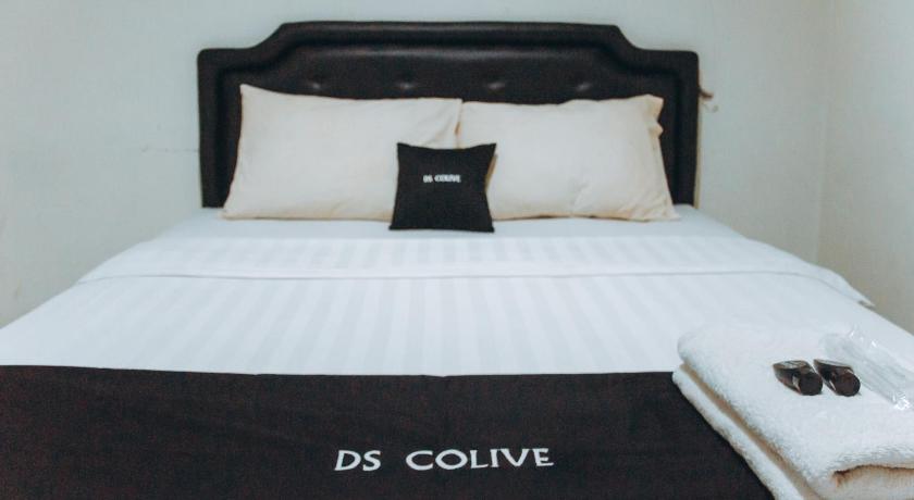 a bed with a white comforter and pillows, DS CoLive Layur in Semarang