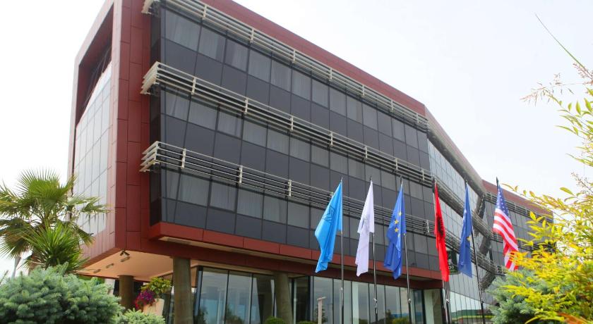 a large building with a flag hanging from the side of it, Best Western Premier Ark Hotel in Tirana