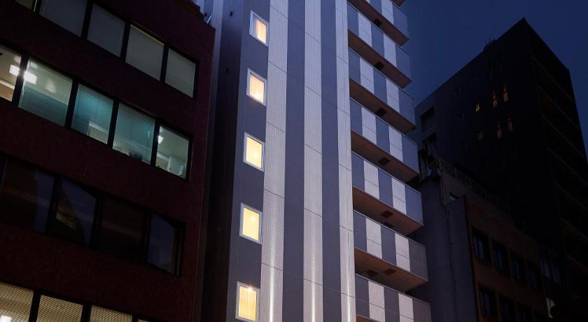 a tall building with a large clock on it's side, Sotetsu Fresa Inn Kanda Otemachi in Tokyo