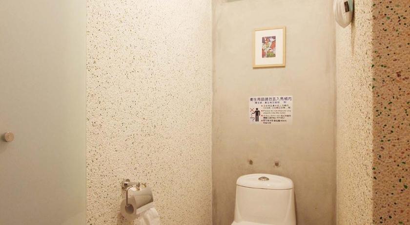 a white toilet sitting in a bathroom next to a wall, Moose & Squirrel in Nantou
