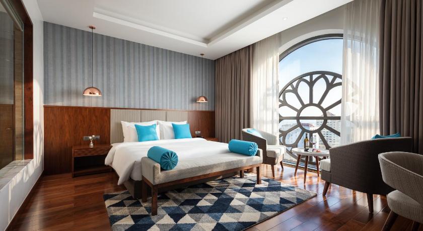 a bedroom with a large bed and a large window, D'Lecia Ha Long Hotel  in Hạ Long