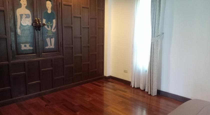 a room with a wooden floor and a wall with pictures on it, Gardenia Oceanfront Villa in Koh Chang
