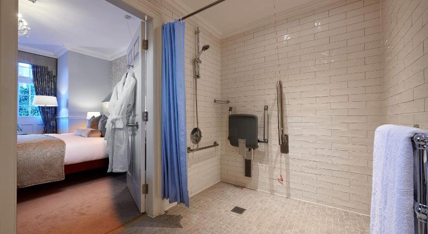 a bathroom with a bed and a shower, The Bonham Hotel in Edinburgh