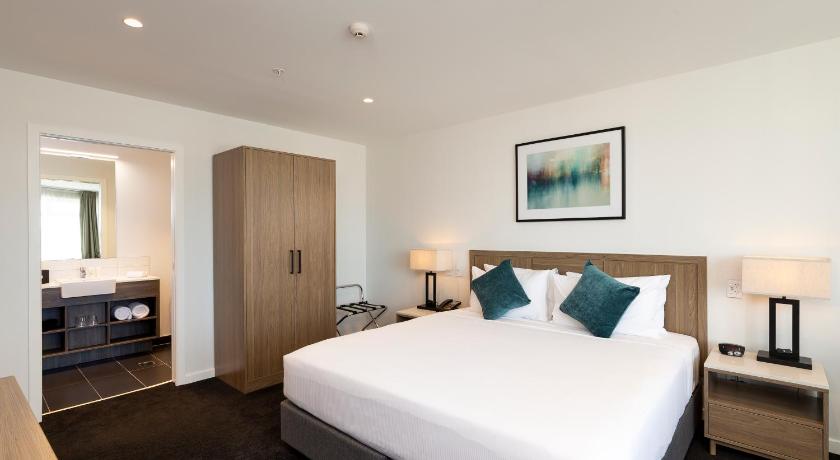 a hotel room with two beds and a television, Nesuto Stadium in Auckland