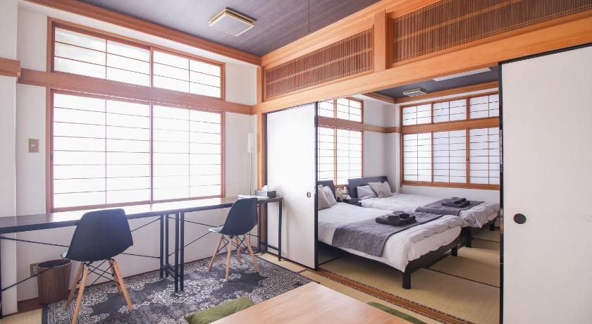a room with a bed, chair and a window, Evergreen Hotel Hatsudai in Tokyo