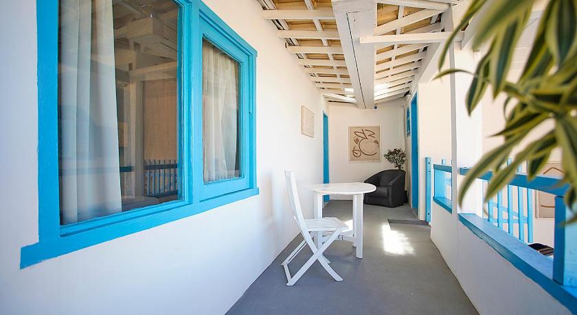 a room with a white couch and a blue door, Sofia's on the Beach in Buzios