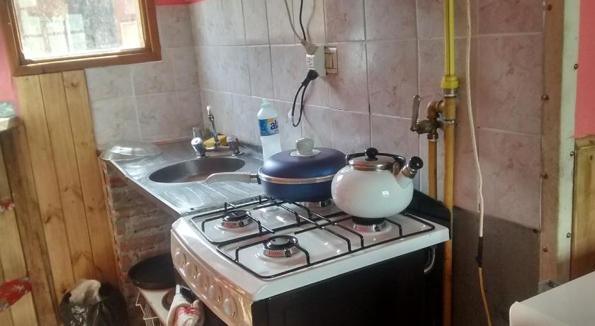 a stove top oven sitting in a kitchen next to a sink, Max in El Chalten