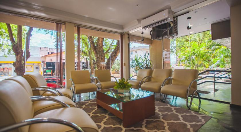 a living room filled with furniture and a large window, Hotel Rafain Centro in Foz Do Iguacu