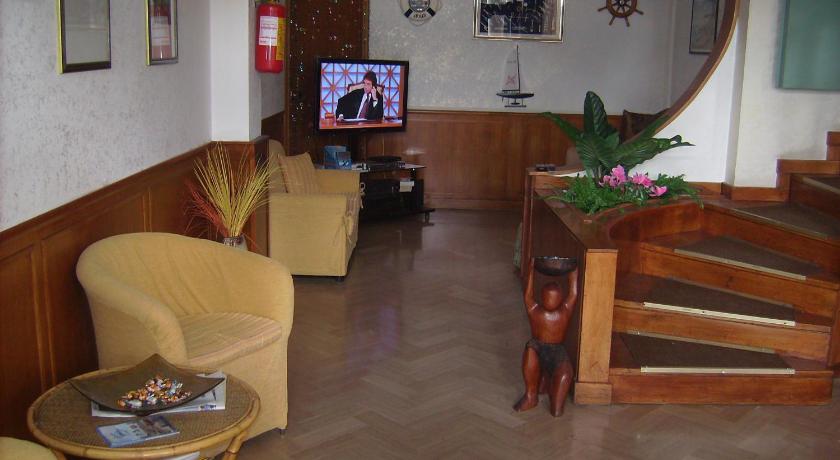 a living room filled with furniture and a tv, Hotel L'Approdo in Brindisi
