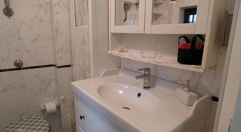 a white toilet sitting next to a sink in a bathroom, Appartamento Via Filippini in Reggio Calabria