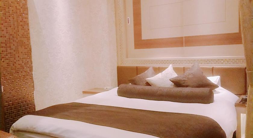 a bedroom with a large bed and a large window, Hotel Lei in Funabashi
