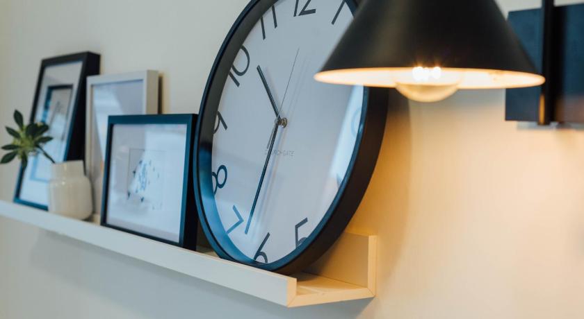 a clock that is on top of a wall, Stylish and Comfortable City Centre Apartment in Edinburgh