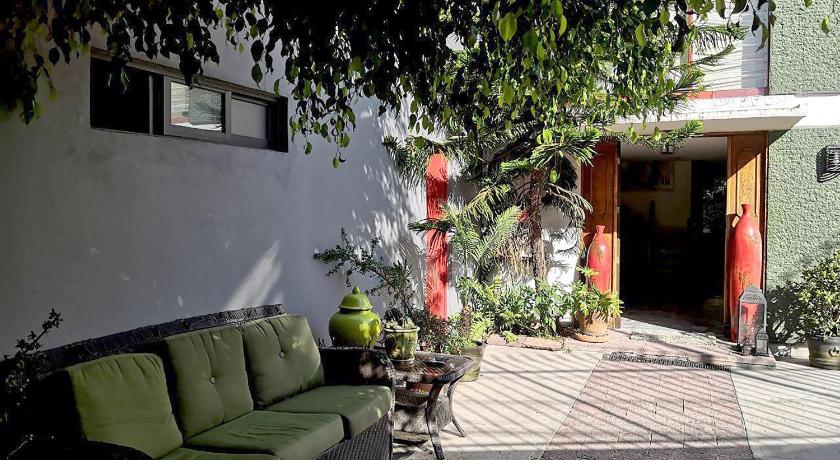 a green couch sitting in front of a house, La Favorita in Mexico City