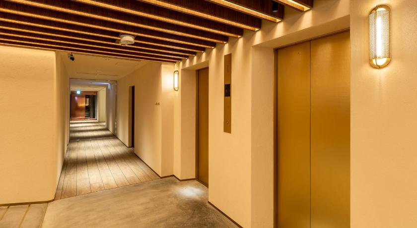 an empty room with a door leading to a hallway, The OneFive Terrace Fukuoka in Fukuoka