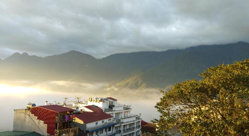 a large building with a view of a mountain range, Nguyen Dang Guesthouse in Sapa