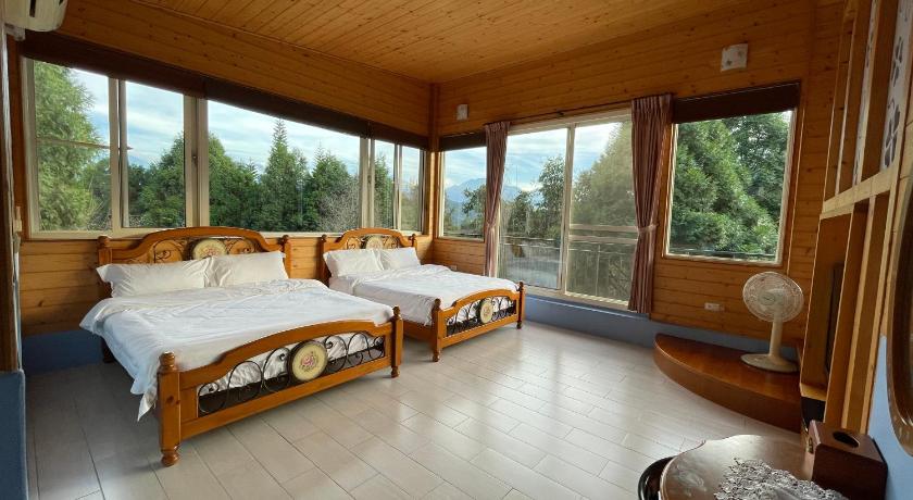 a bedroom with a large bed and a large window, View on View B & B in Nantou