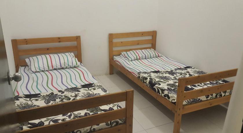 two beds in a small room, HOMESTAY EIJAZ KUALA  ROMPIN in Kuala Rompin