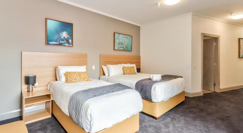a hotel room with a bed and a desk, Meridian Hotel Hurstville in Sydney