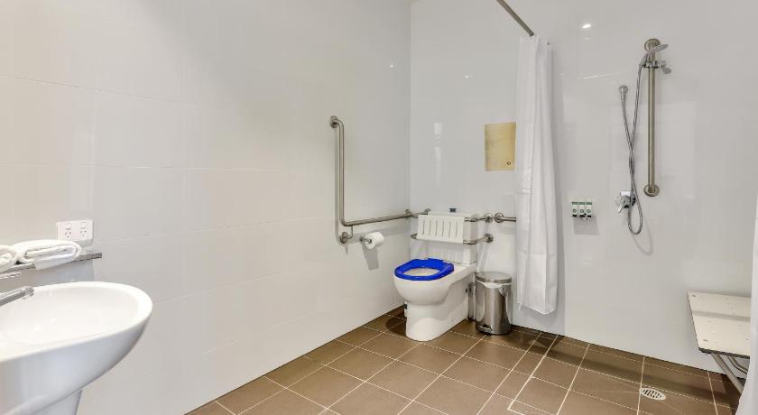 a bathroom with a toilet, sink, and shower, Meridian Hotel Hurstville in Sydney