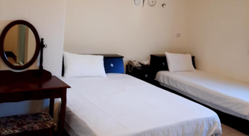 a hotel room with a bed and a desk, jiou wu siao jhu in Matsu Island