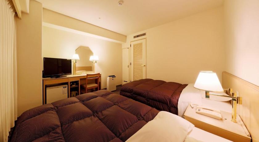 a hotel room with two beds and a television, Yonago Washington Hotel Plaza in Yonago