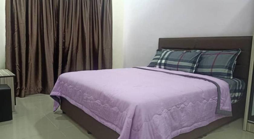 a bed with a white comforter and pillows, KS 80 Homestay 15pax 4R3B  Wifi near Jetty in Kuala Selangor