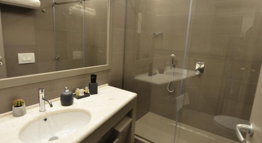 a bathroom with a sink, toilet and shower, Petit Hotel Elita in Shkoder