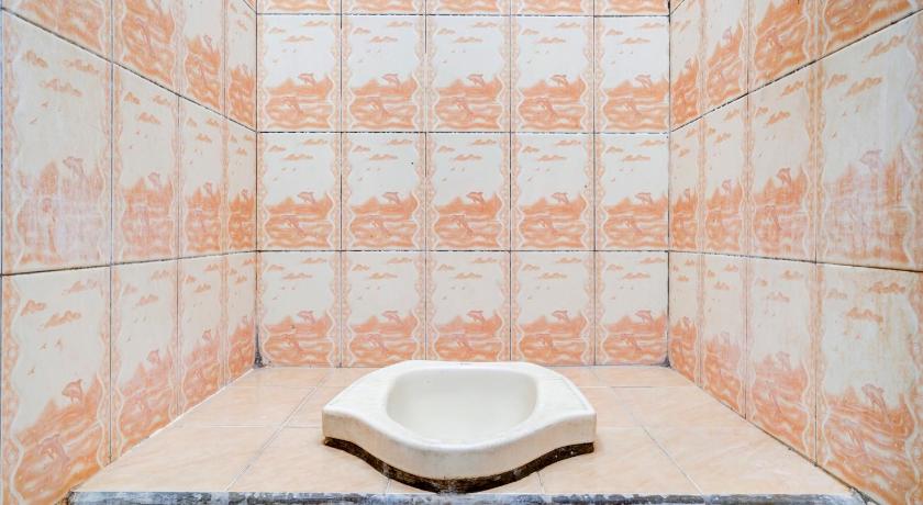 a white toilet sitting in a bathroom next to a sink, Super OYO 90118 Hotel Diamond Syariah in Bandung