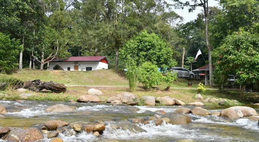 a house with a river running through it, Lubok Jong Riverside, Sedim in Karangan