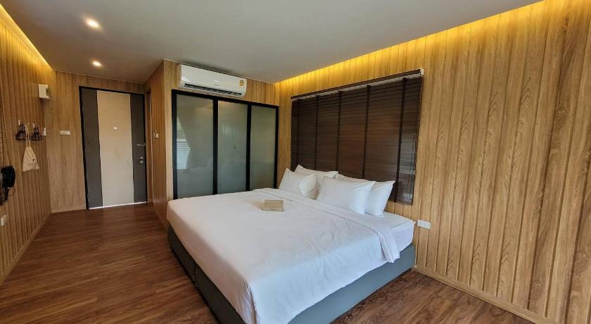 a bedroom with a bed and a dresser, Sunnyvale Ranong 2 in Ranong
