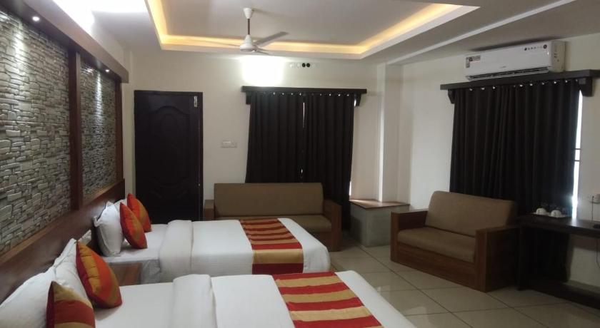 a living room filled with furniture and a couch, HISHAM SUITES in Kochi