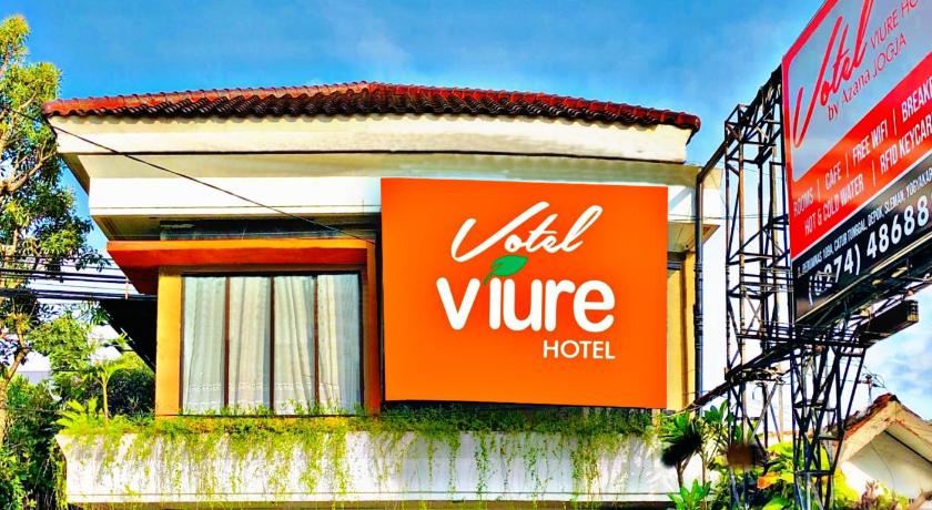 a building with a sign on the side of it, Votel Viure Hotel in Yogyakarta
