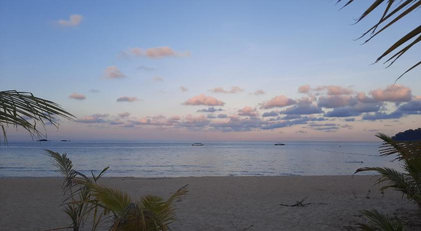 a beach with palm trees and palm trees, juara seaview chalet, kampung juara in Tioman Island