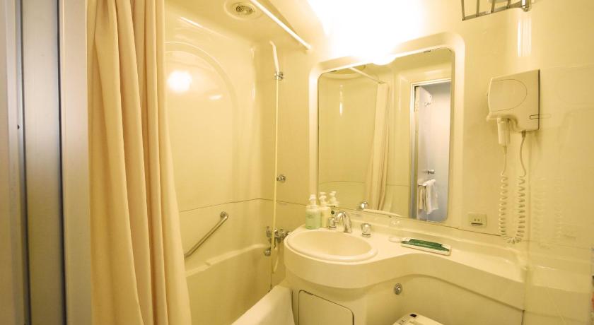 a bathroom with a toilet, sink and shower, Hotel Route Inn Chitose Ekimae in Sapporo