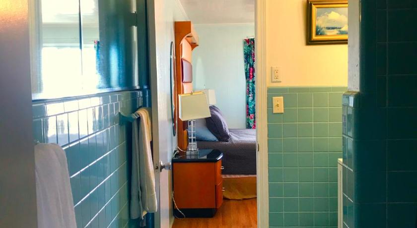 a room with a toilet and a sink in it, The Colony Apartments in Ocean City (MD)