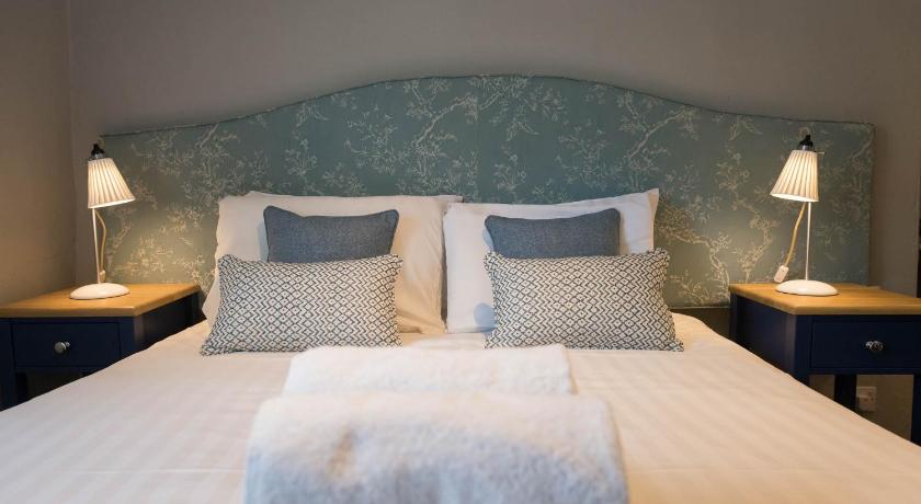 a bed with a white comforter and pillows, The Horse and Farrier Inn and The Salutation Inn Threlkeld Keswick in Threlkeld