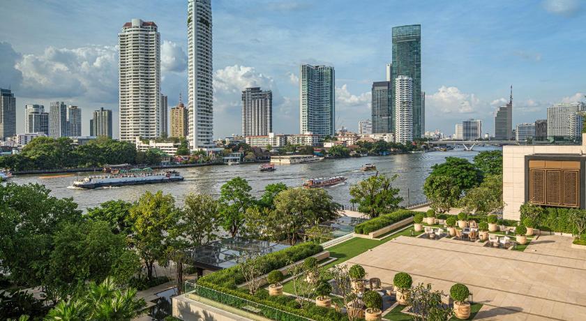 a cityscape of a city with tall buildings, Four Seasons Hotel Bangkok at Chao Phraya River in Bangkok