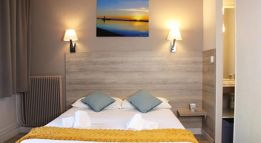 a hotel room with a bed and a lamp, Azureva Cap d'Agde in Agde