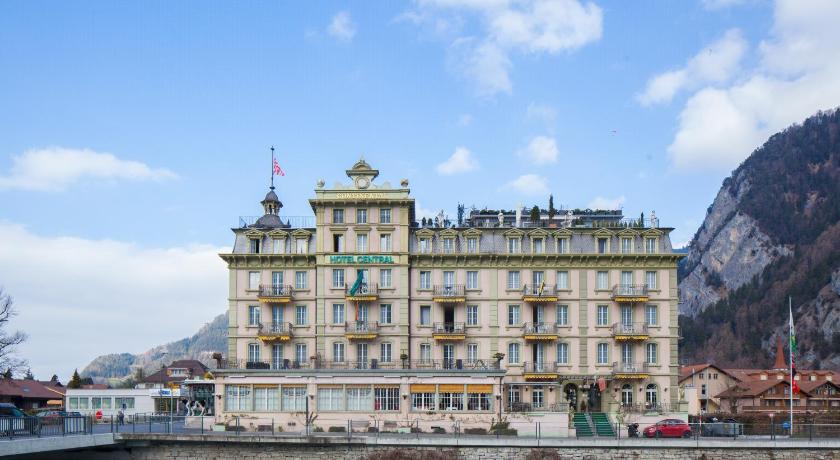 a large building with a clock tower on top of it, Hotel Central-Continental in Interlaken