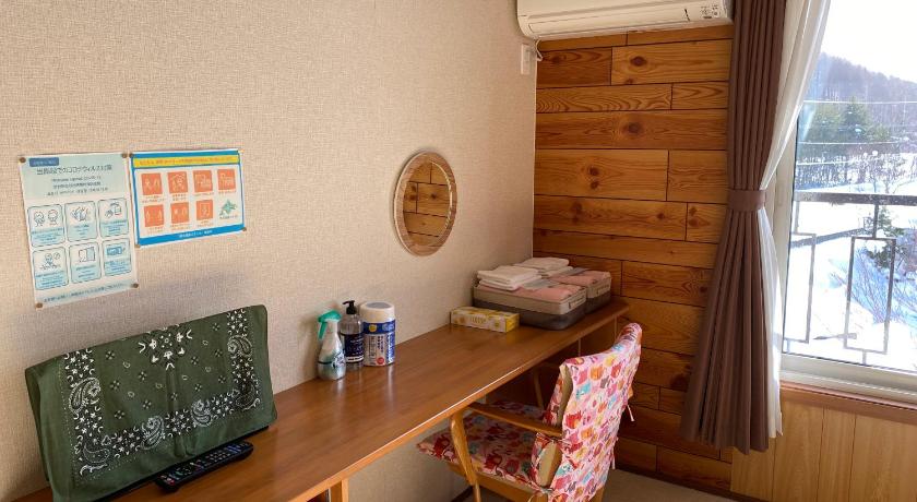 a living room with a desk and a chair, Coro Coro in Furano