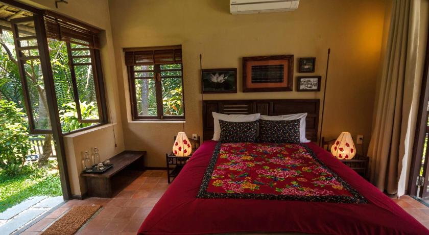 a bedroom with a bed and a window, An Villa in Hoi An