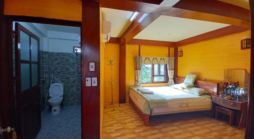 a bedroom with a bed and a dresser, Mai Chau Hostel - Bar Restaurant in Mai Chau (Hoa Binh)